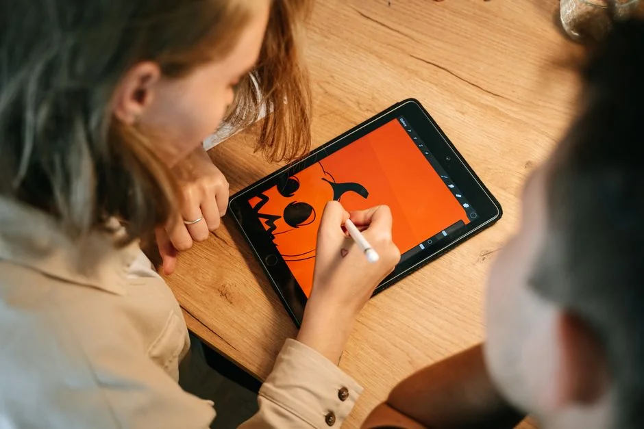 A silhouette of a fashion designer examining a creative mood board filled with fashion sketches and photos.